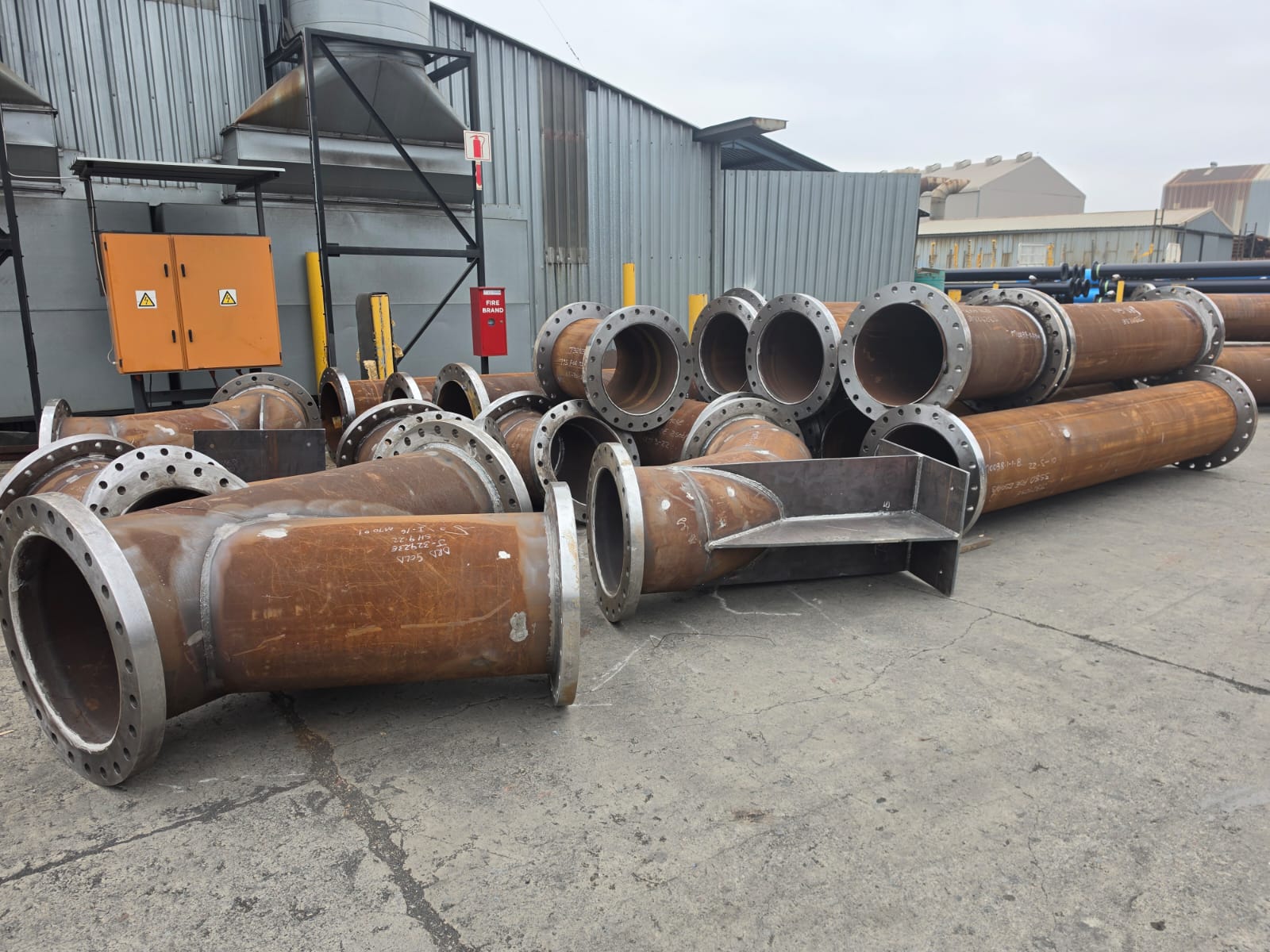 Custom fabricated steel pipe bends and tees with welded flanges at Wetpipe